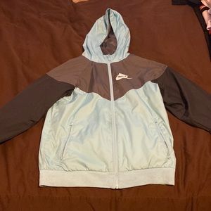 Youth Nike windbreaker. Colors- Baby blue, Gray, white, black. Size- Youth Large
